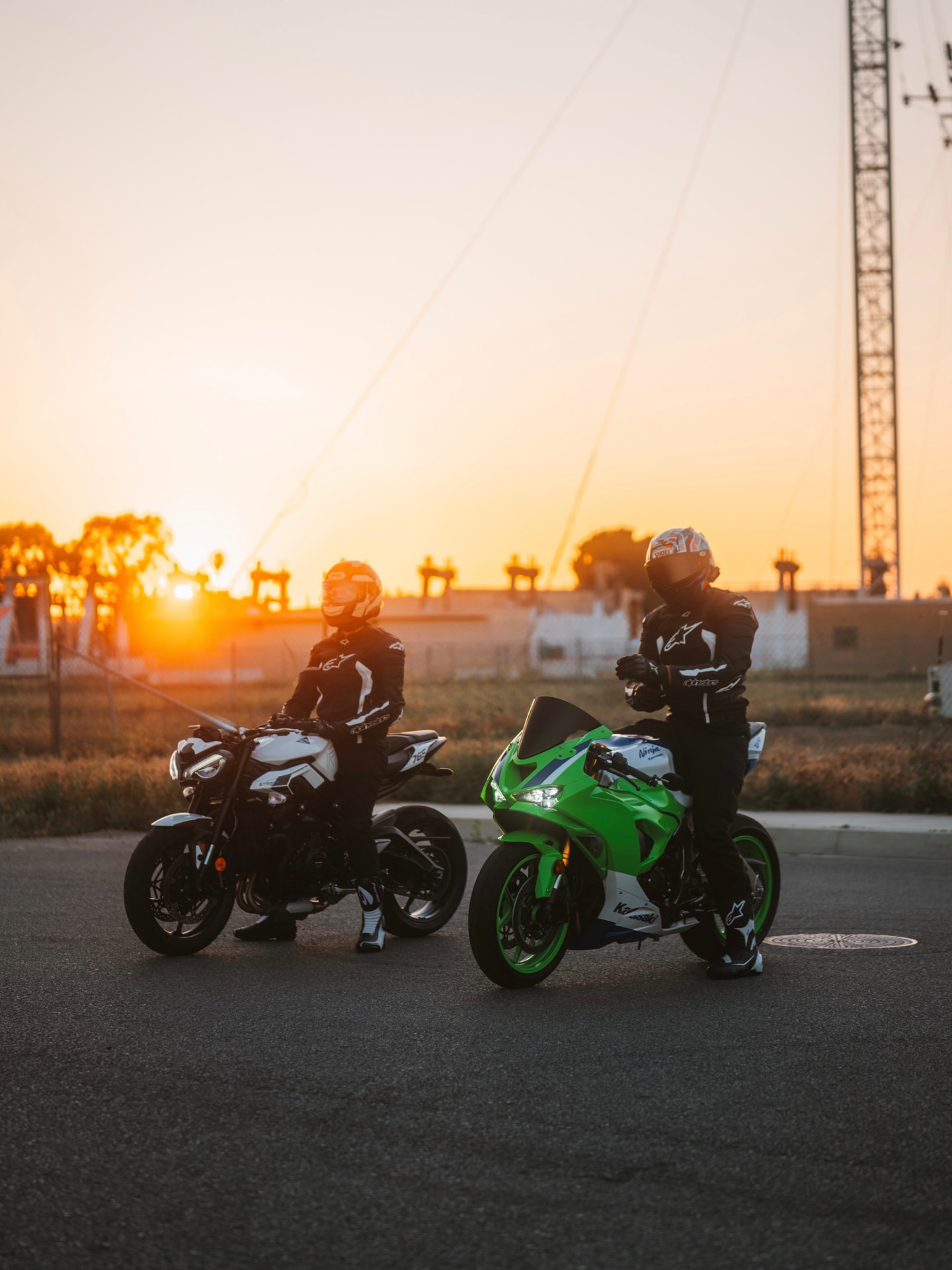 Rennsport founder with a fellow rider at sunset, both on their bikes